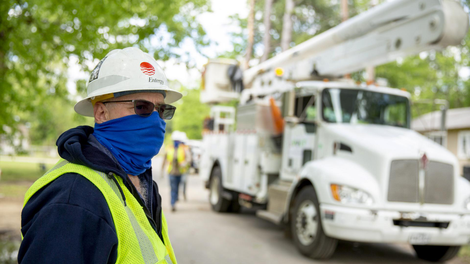 Maintaining social distancing and wearing protective masks adds to the challenge of restoring power to 128,000 customers. This scene was in Smackover Tuesday. 
